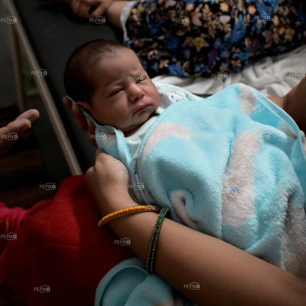 
									Adorable look of New born baby boy in  sky blue dress