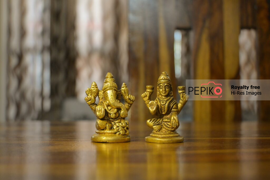 Close up of Lord Ganesh and Devi Laxmi small statues on festival celebrations.