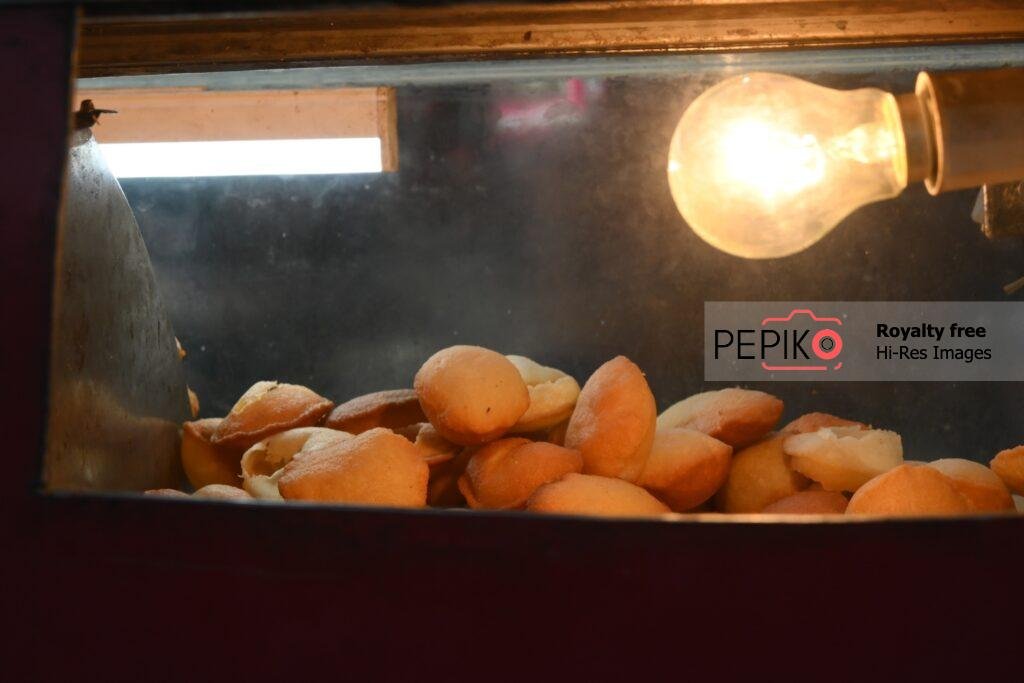 
									Indian Street food, this is called pani puri and it tastes tangy.