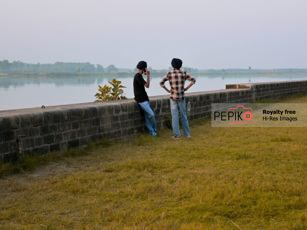 
									Young boys from Punjab admiring the beauty of water Dam located at Ropar Punjab India