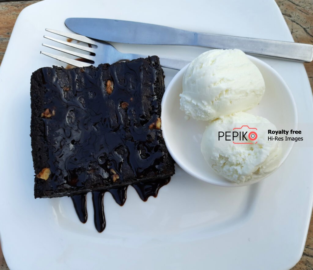 
									Walnut Chocolate brownie with vanilla ice cream at river side restaurant in India