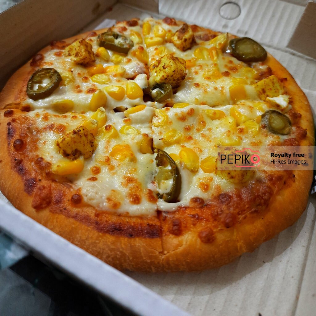 Top view of Sweet corn, cheese and jalapeno pizza