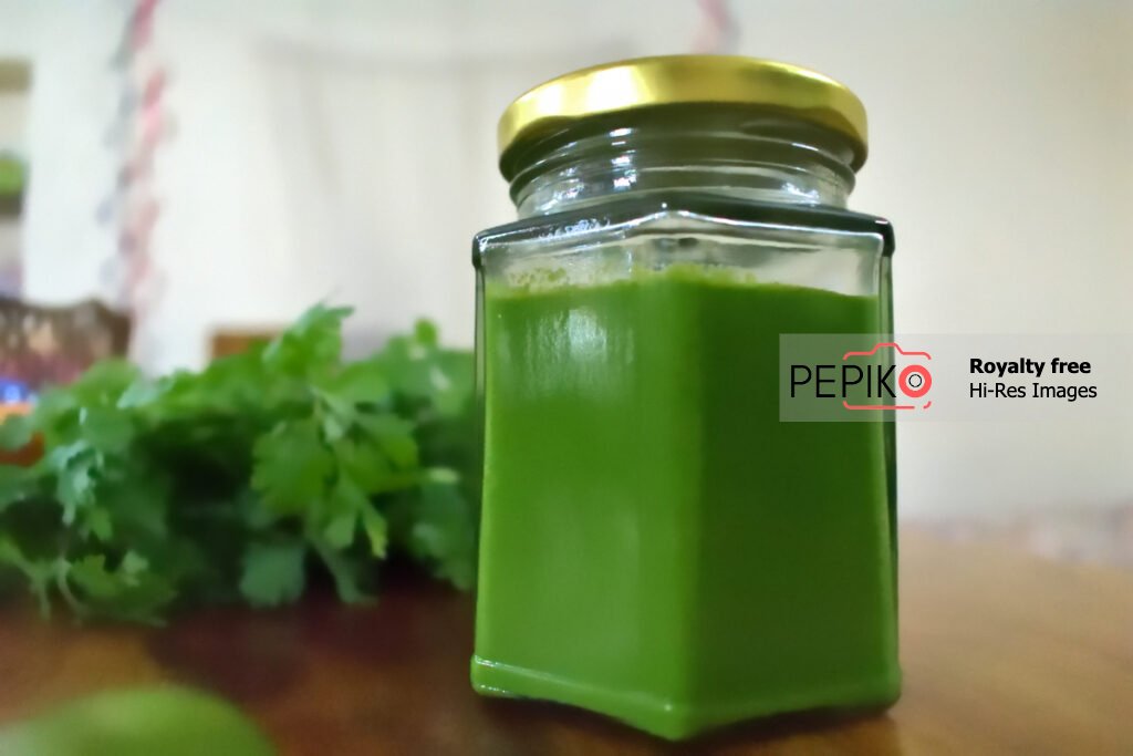 
									Picture of Green mint and chili chutney in glass jar