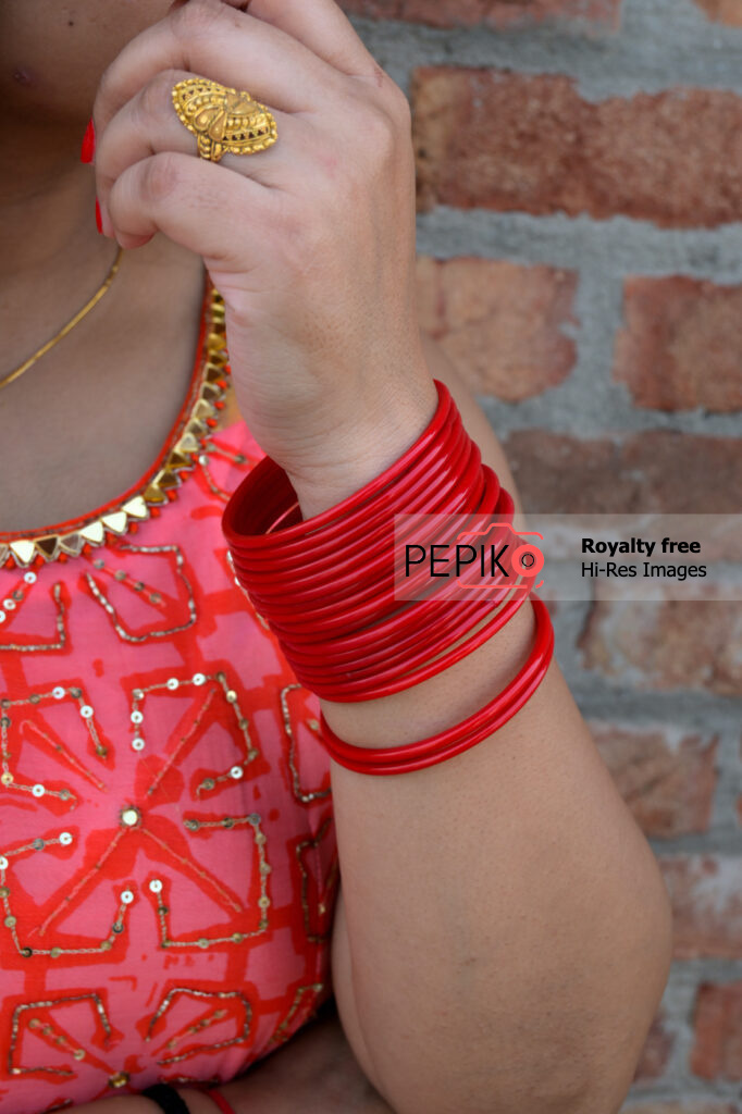 Another Close up of hand with vibrant red bangles