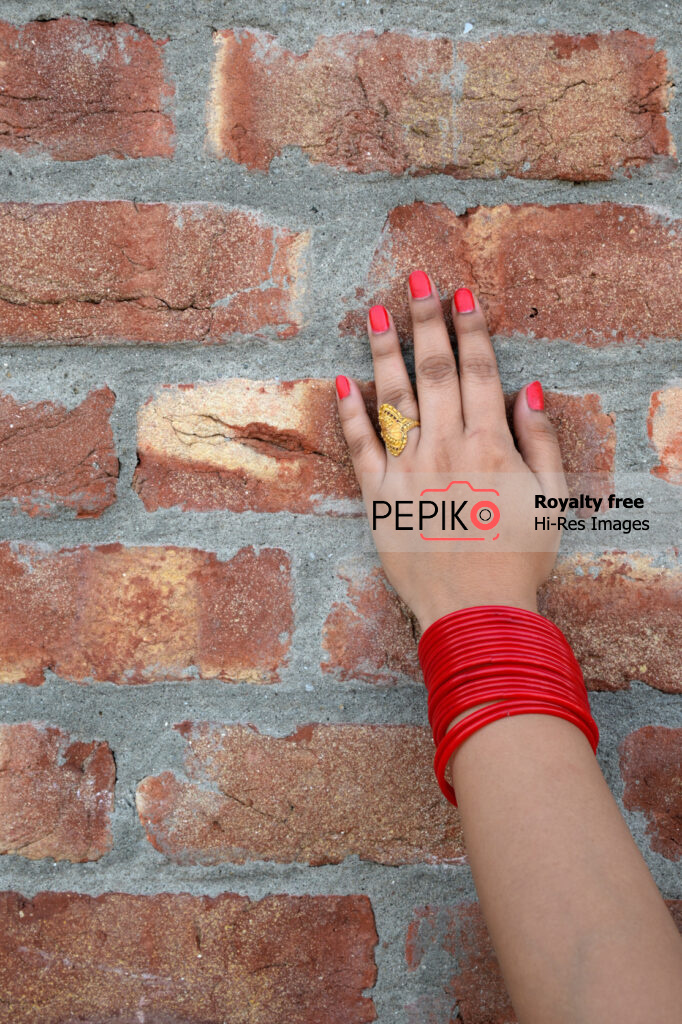 Close up of hand with red bangles