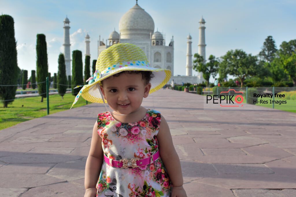 1 year old infant enjoying the Taj Mahal in Agra wearing floral dress