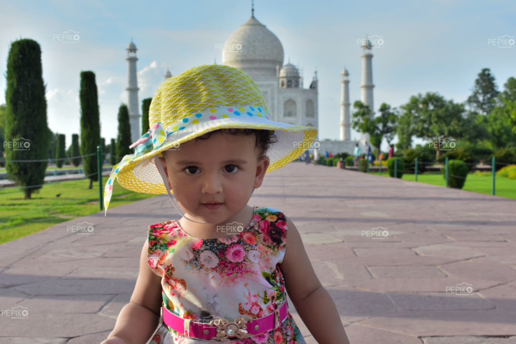 One more click of Cute girl child enjoying the Taj Mahal in Agra wearing floral dress