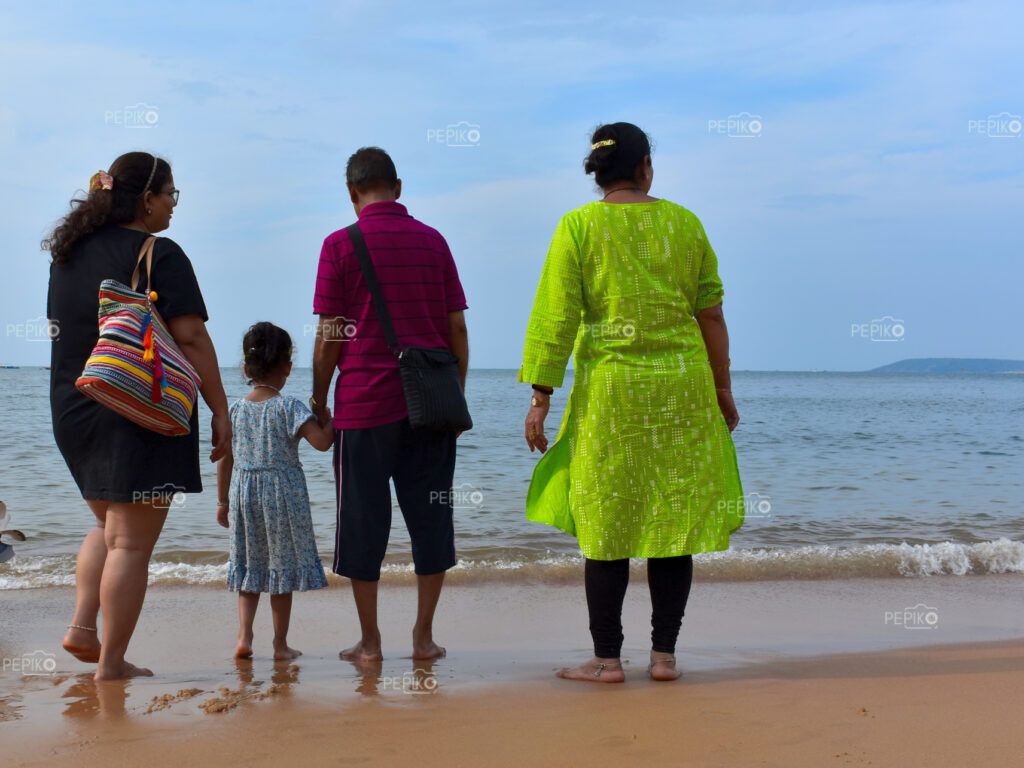 Beautiful pictures of old mature, young child, man & women travelers in GOA India enjoying at water sand beach