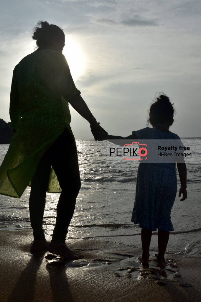 
									Beautiful pictures of old mature lady with young child traveler in GOA India enjoying at water sand beach