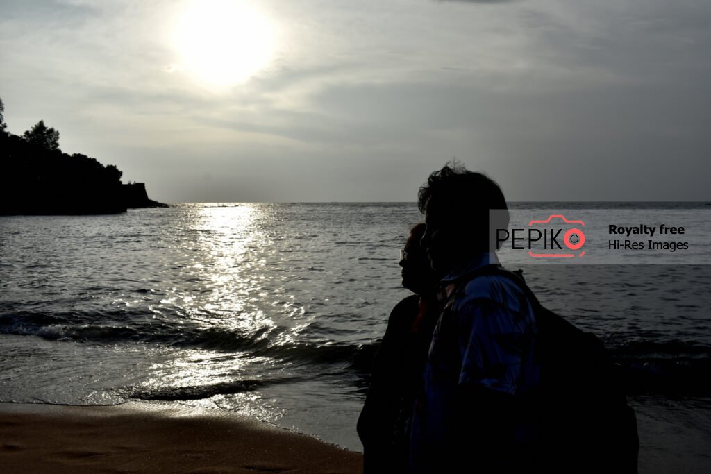 
									Young couple travelers in GOA India enjoying at water sand beach