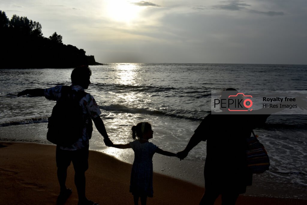 
									Young couple with their kid traveling in GOA India and enjoying at water sand beach