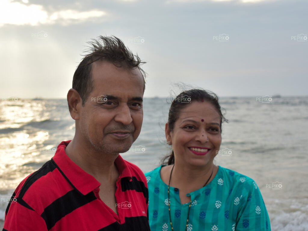 
									Mature couple enjoying at beach