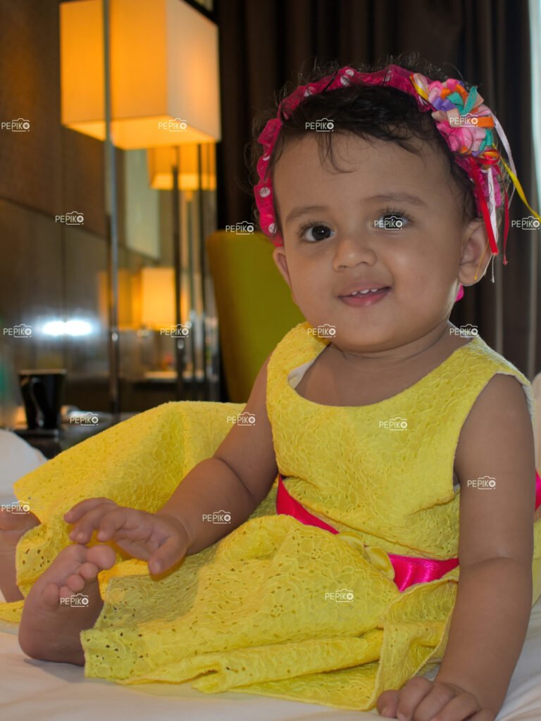 Portrait of cute child in yellow dress