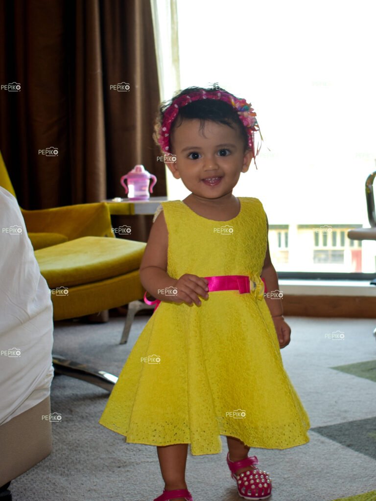 Nice picture of a 1 year old girl child smiling in yellow skirt