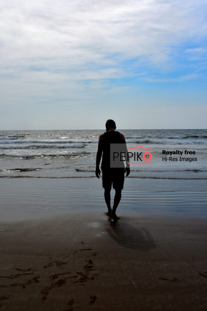 Picture of a man walking alone on beach of GOA India