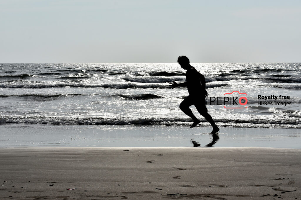 Picture of man running on beach