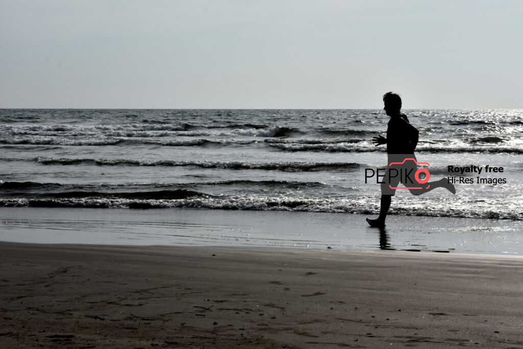 Picture of athlete running training on beach