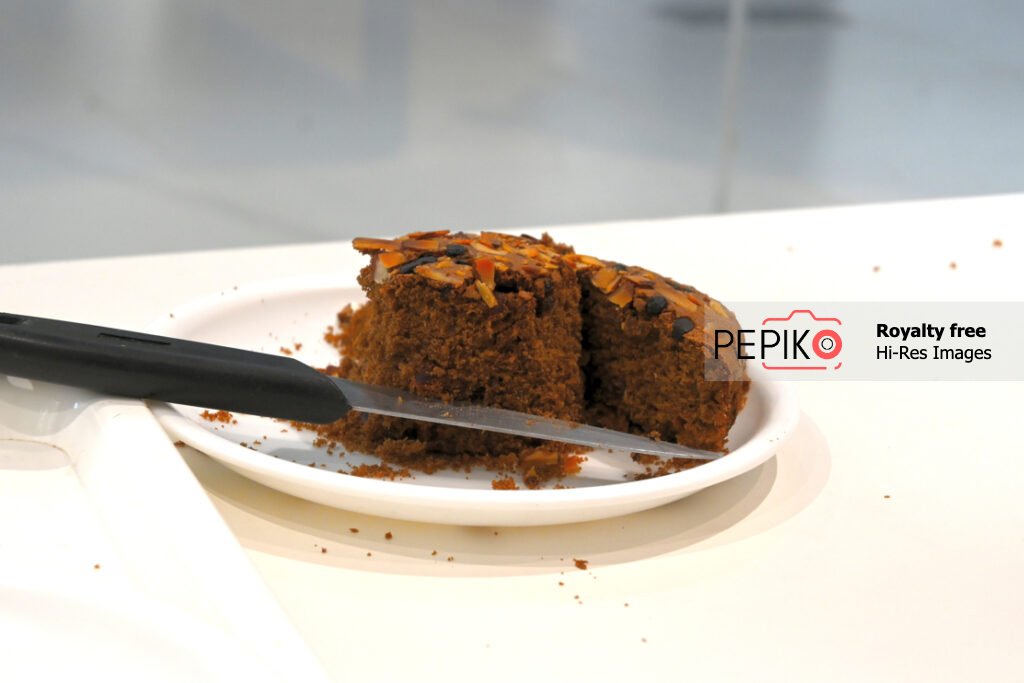 Picture of Dry fruit cake with knife sliced and eaten