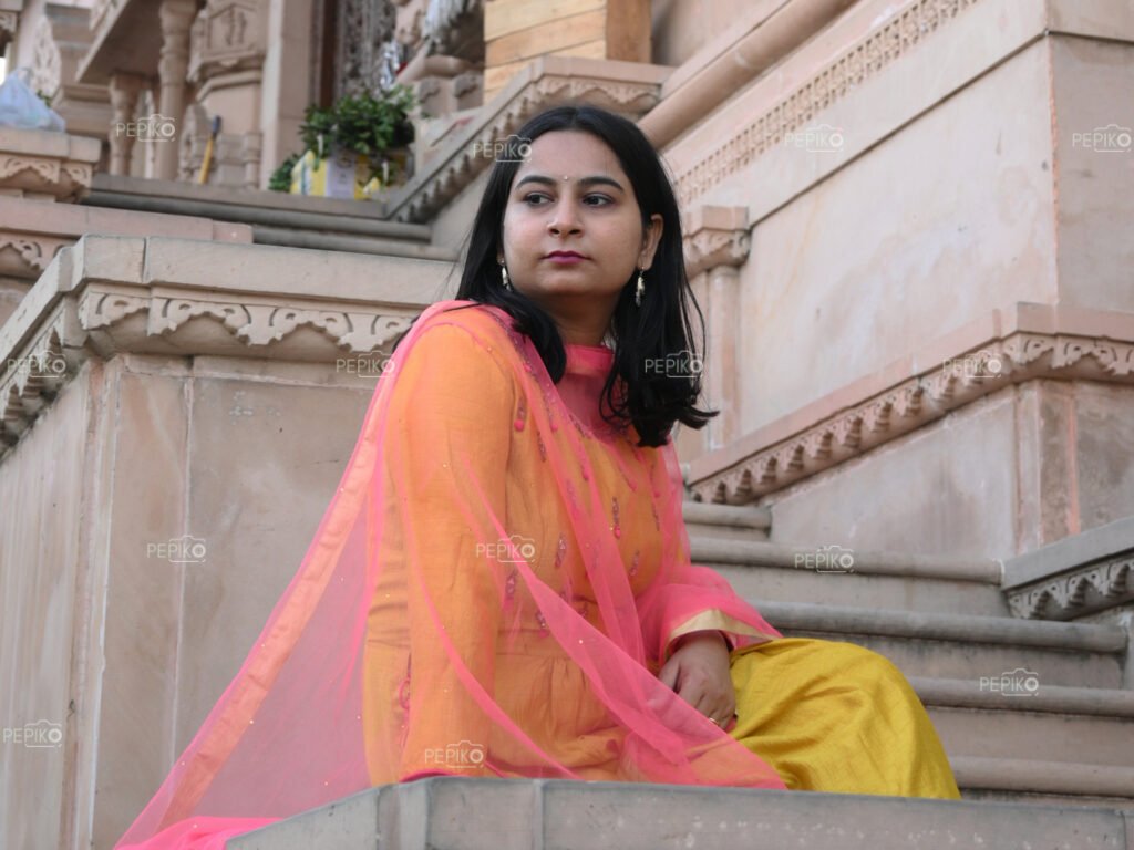 Portrait of an Indian women with yellow dress in an Indian temple