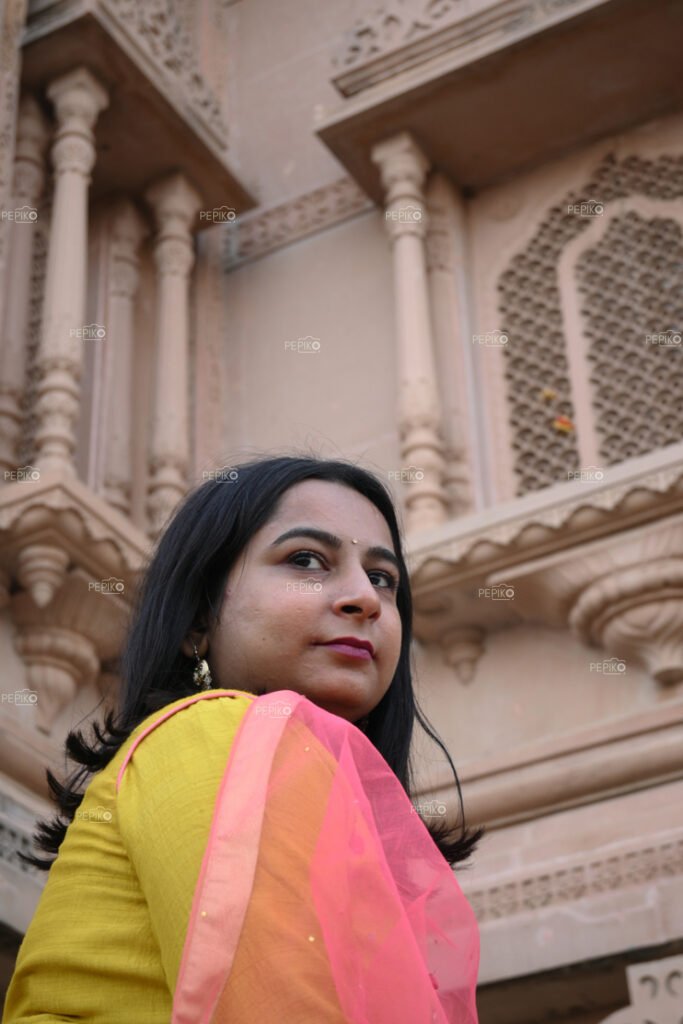 Closeup of an Indian women with yellow dress in temple