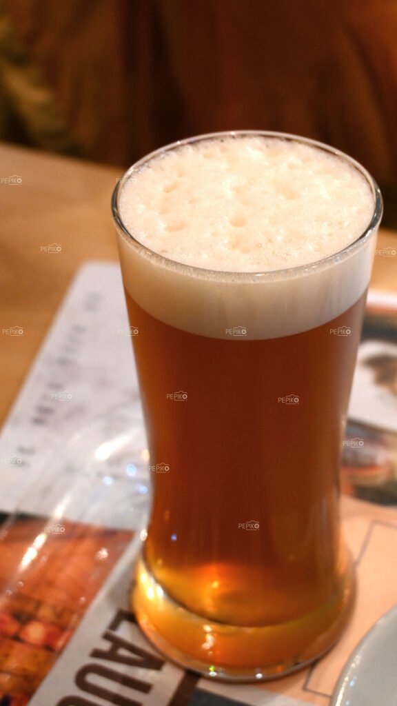 Glass full of beer / fruit juice / beverage / liquid / wine on table