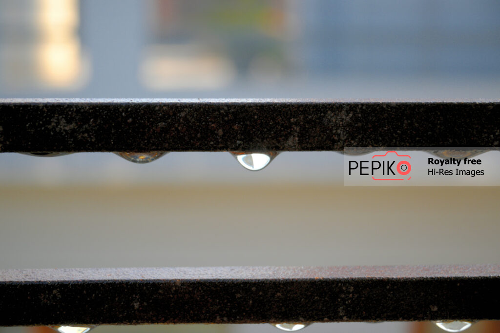 Closeup of water drop / droplet on iron bar during rain