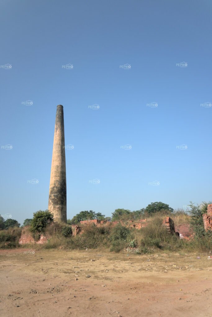 Picture of massive chimney at brick manufacturing facility / factory