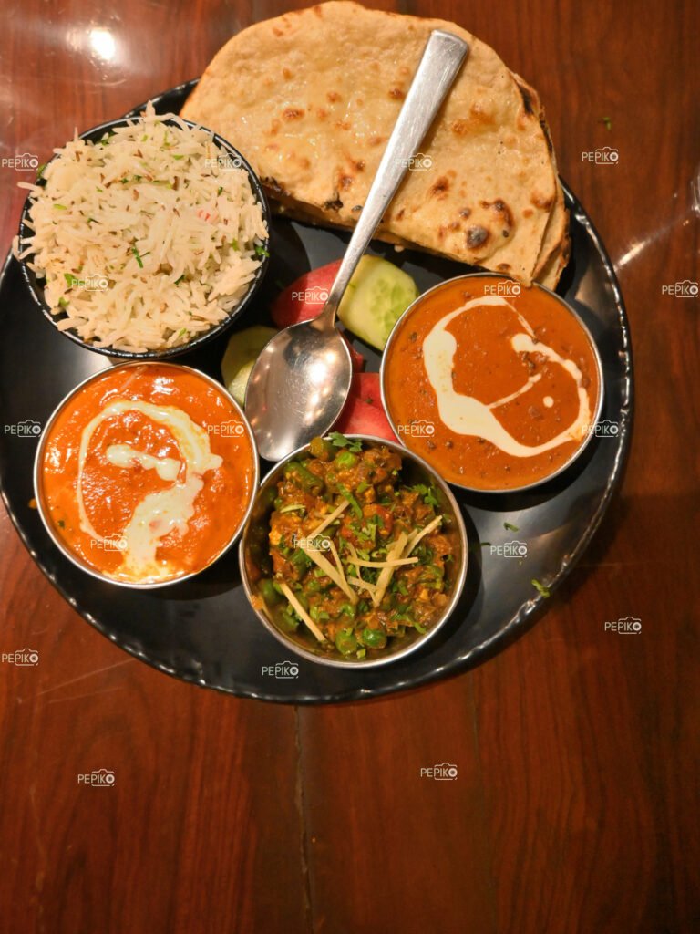 A plate full of variety of Indian vegetables and rice