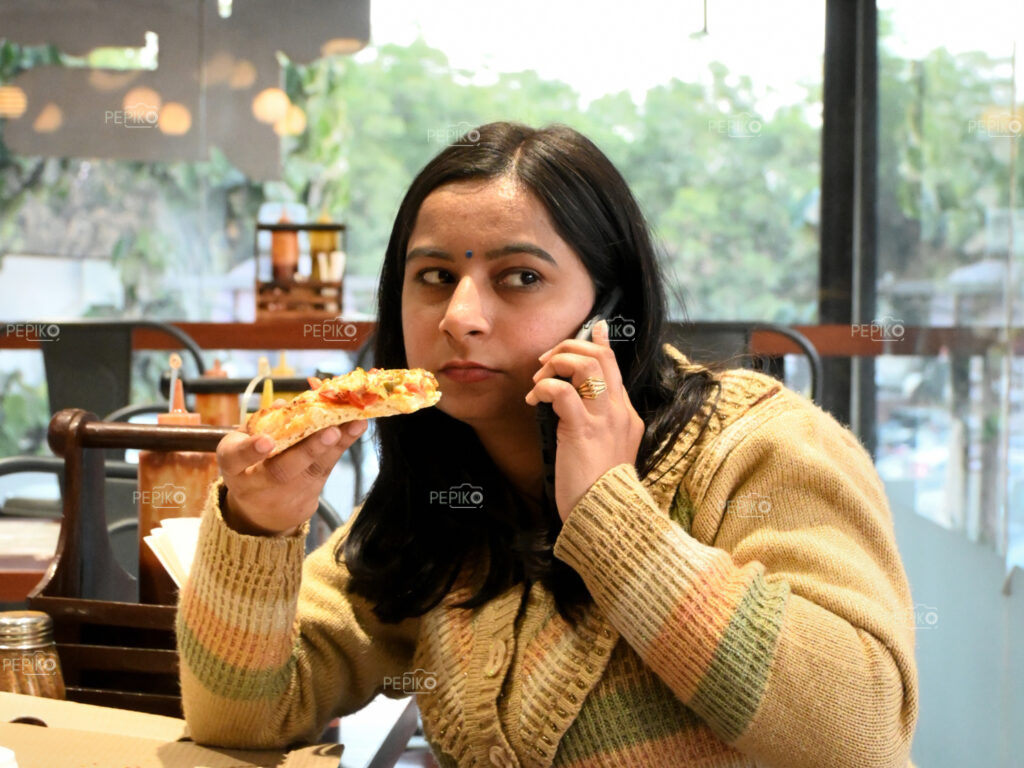 Women with slice of pizza in her hand