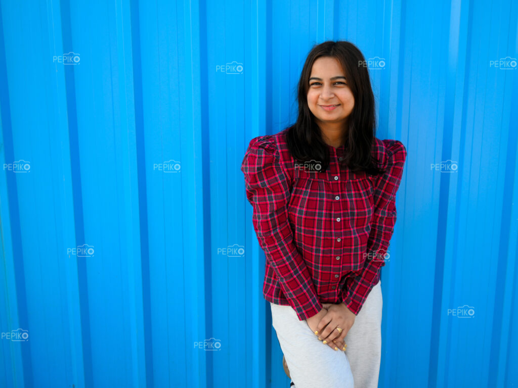 Portrait of women wearing a smile with blue background