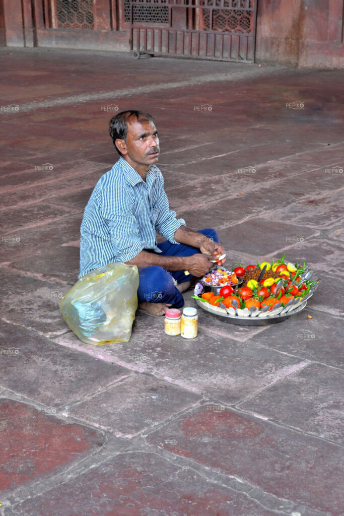 
									Indian Man selling salads on streets